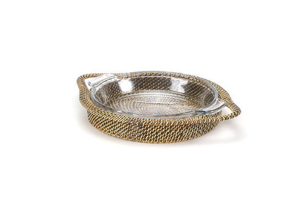 Handwoven round pie dish holder with handles holding a baked apple pie in an Anchor glass pie plate