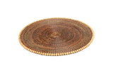 A round placemat with natural wood beads, handcrafted from natural vines.