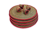 Set of woven placemats with red trim on a white background