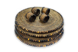 Set of woven placemats with beaded trim on a white background