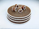 Set of brown and white beaded bracelets on a light gray background