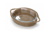 An oval glass baking dish with clear handles, encased in a woven brown basket-style outer sleeve, shown on a white background.