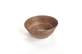 Handwoven round bowl basket for white eggs on kitchen counter