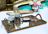 Tea set on a tray with flowers by a poolside