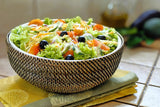 Bowl of salad with vegetables on a wooden table